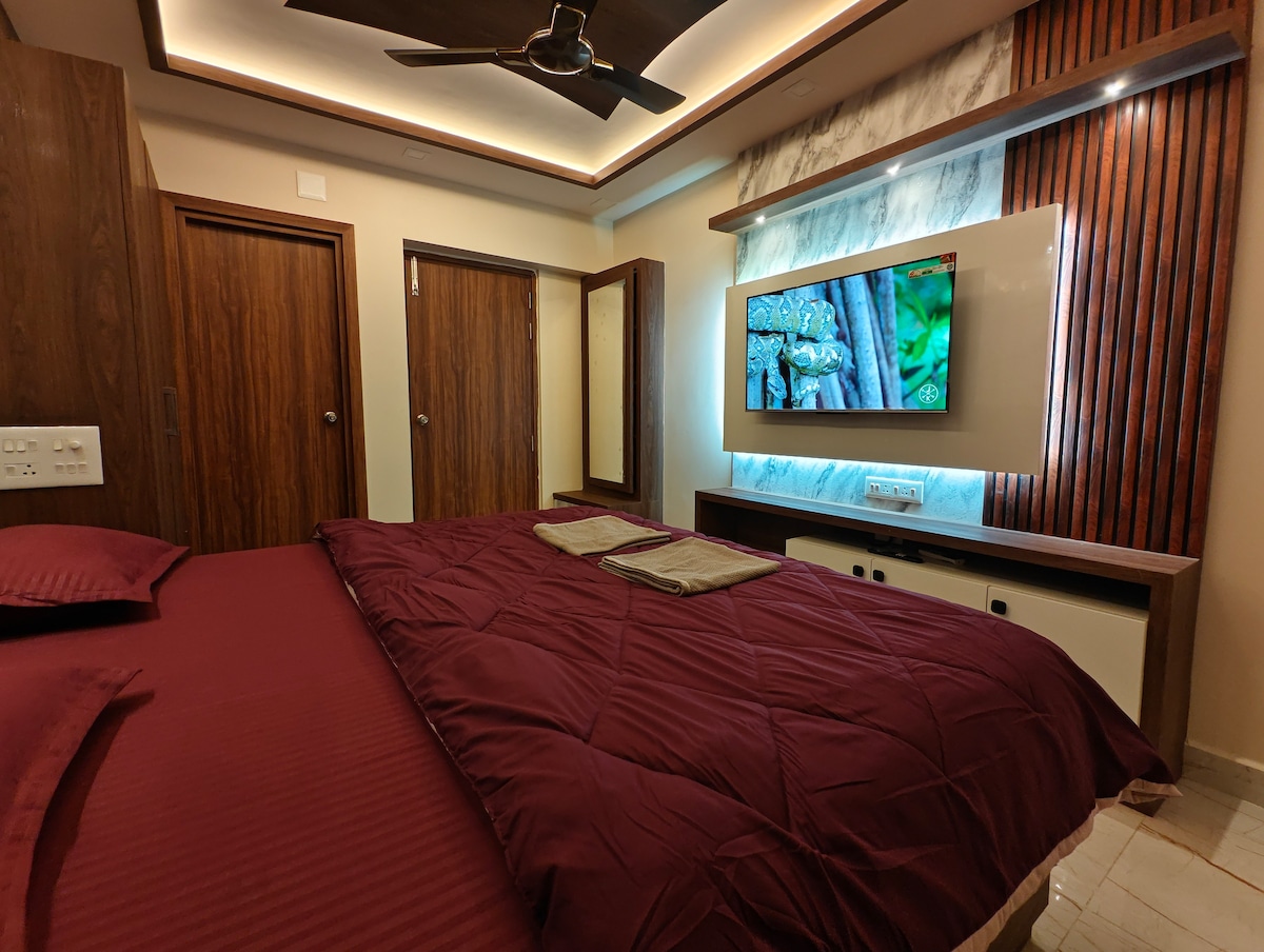 Bedroom with king-size bed and wooden wall panelling